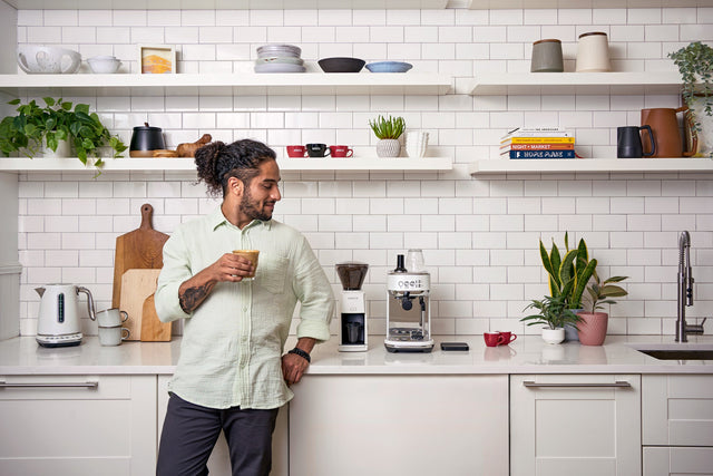 Baratza Encore ESP Espresso Grinder, from Clive Coffee, person enjoying espresso, lifestyle large