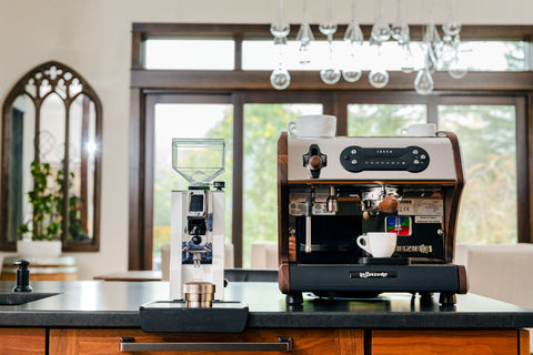 A53 Mini Espresso Machine with walnut wood accents and the white Eureka Mignon Oro XL espresso grinder