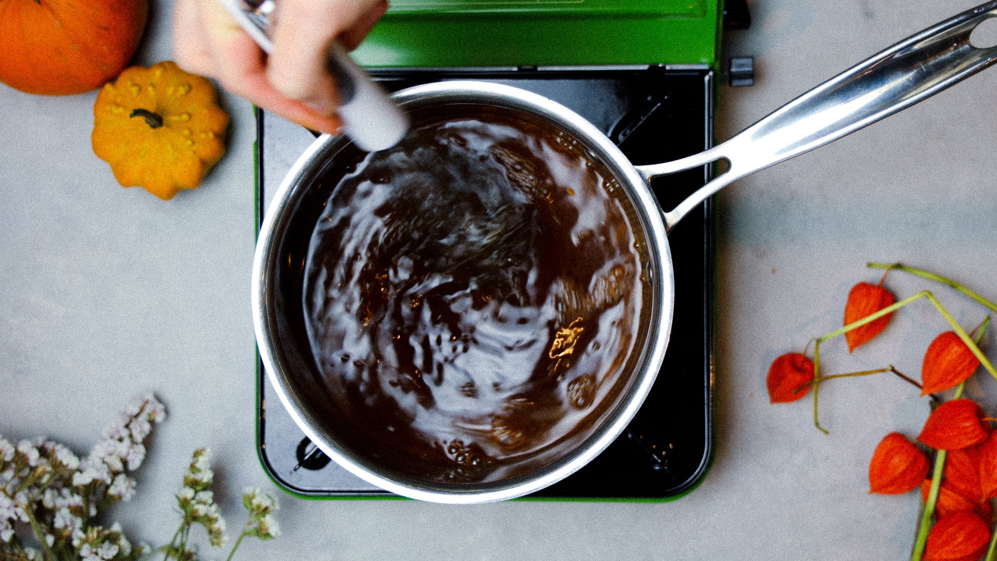 whisking homemade syrup on a stovetop for a latte.